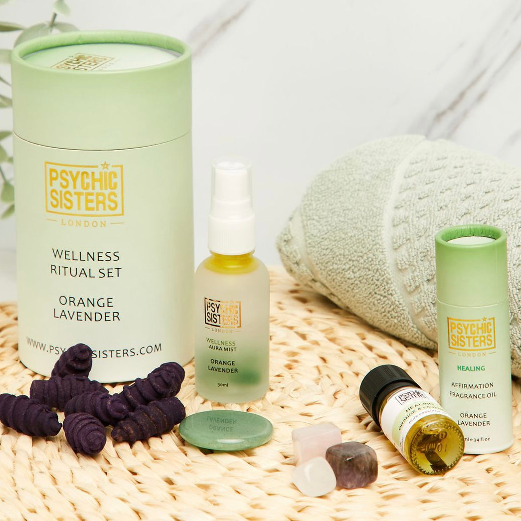 Wellness Ritual Set featuring orange and lavender aromatherapy products and Reiki-energised crystals.